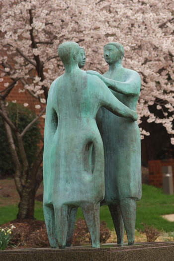 Bronze statue of three people embracing "Communitas" on the campus of ӽ紫ý, Fairfax, VA USA